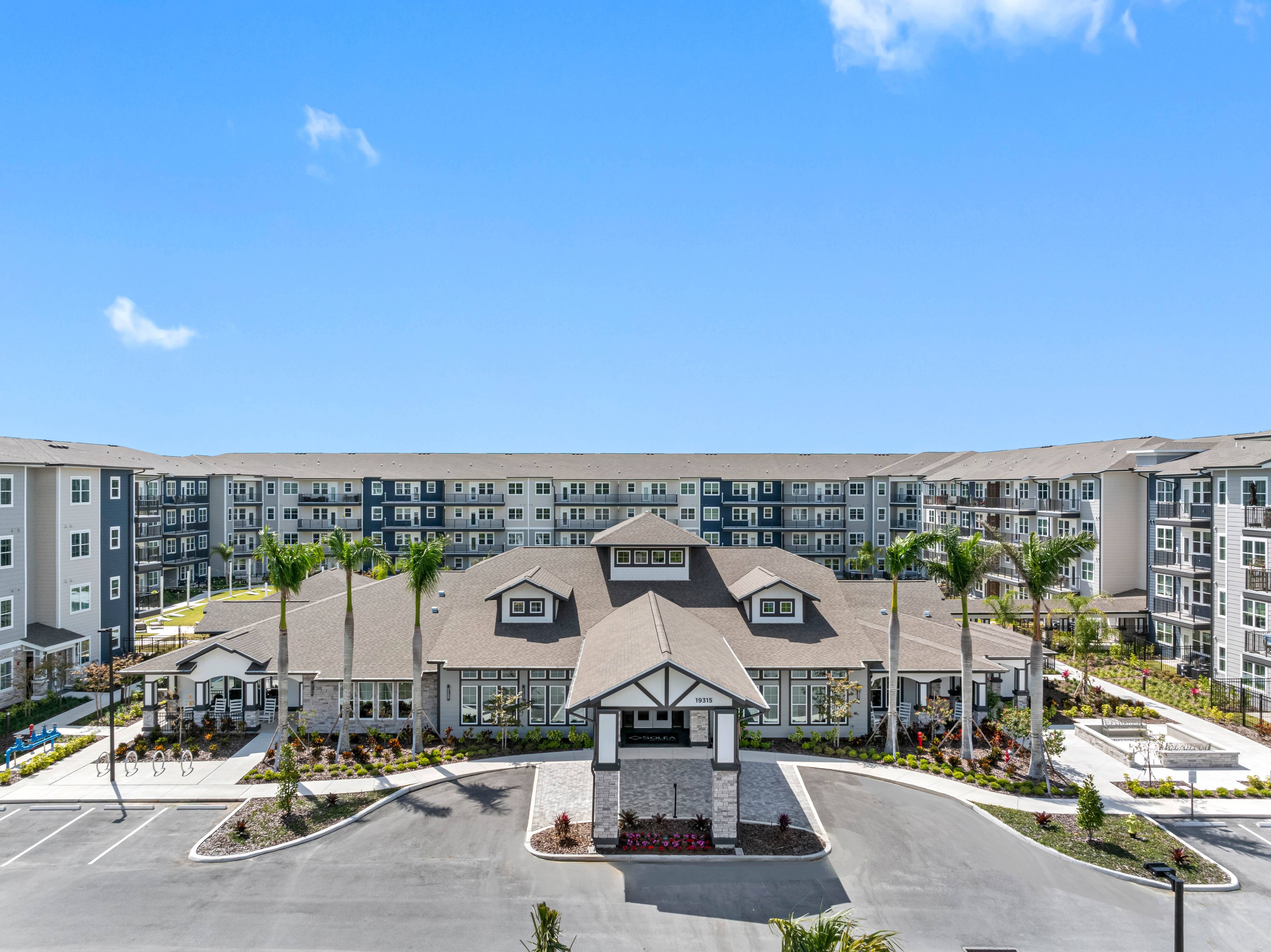 A large building with a parking lot in front of it.